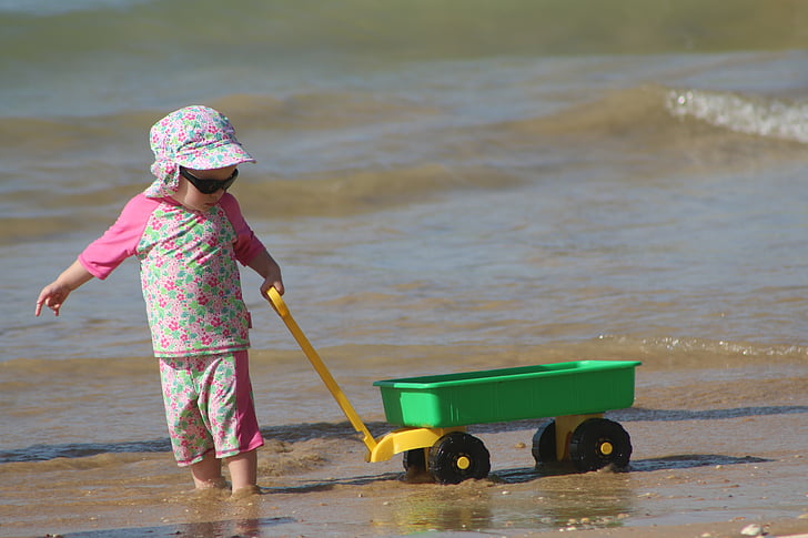 child-playing-beach-in-the-sand