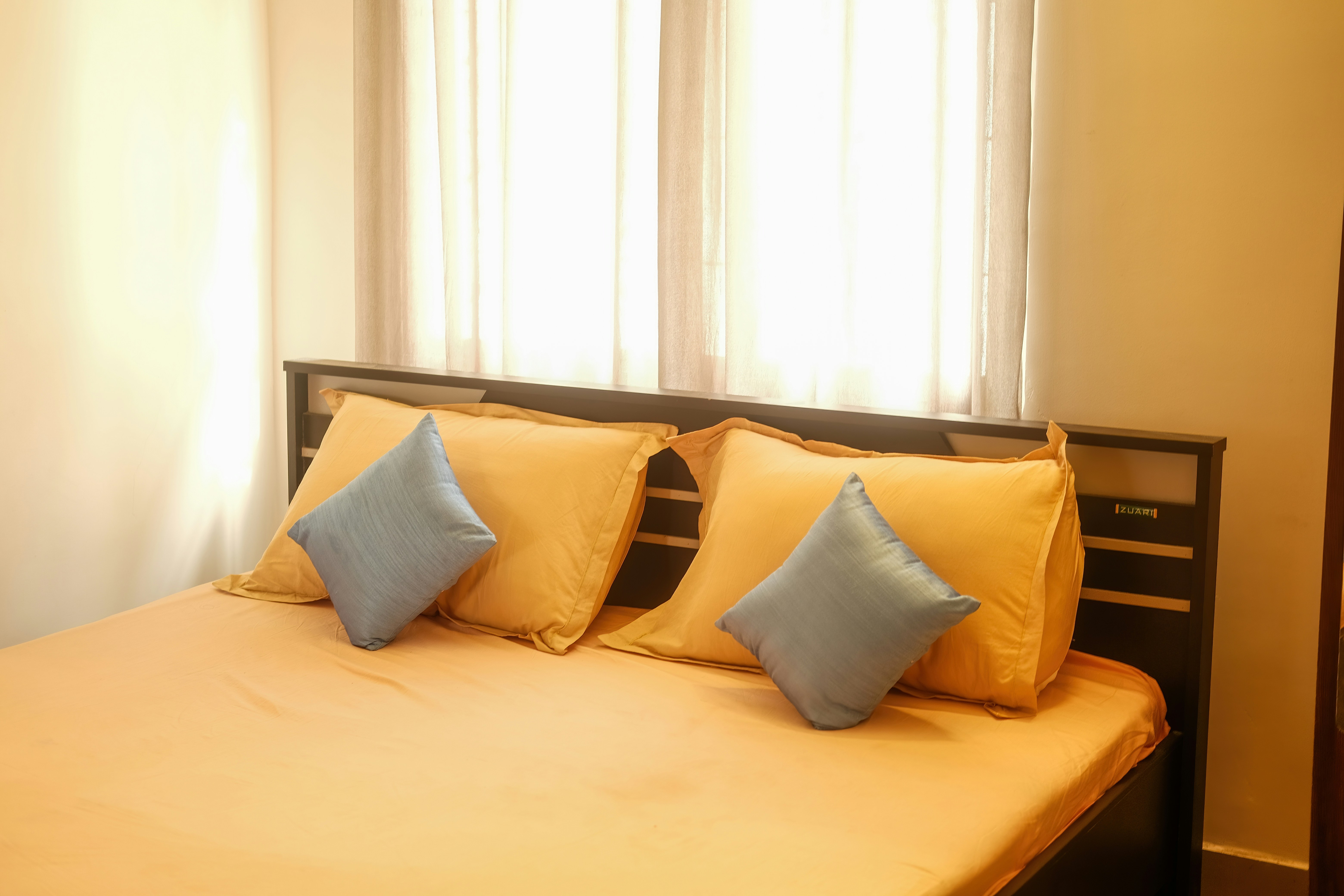 a bed with four pillows