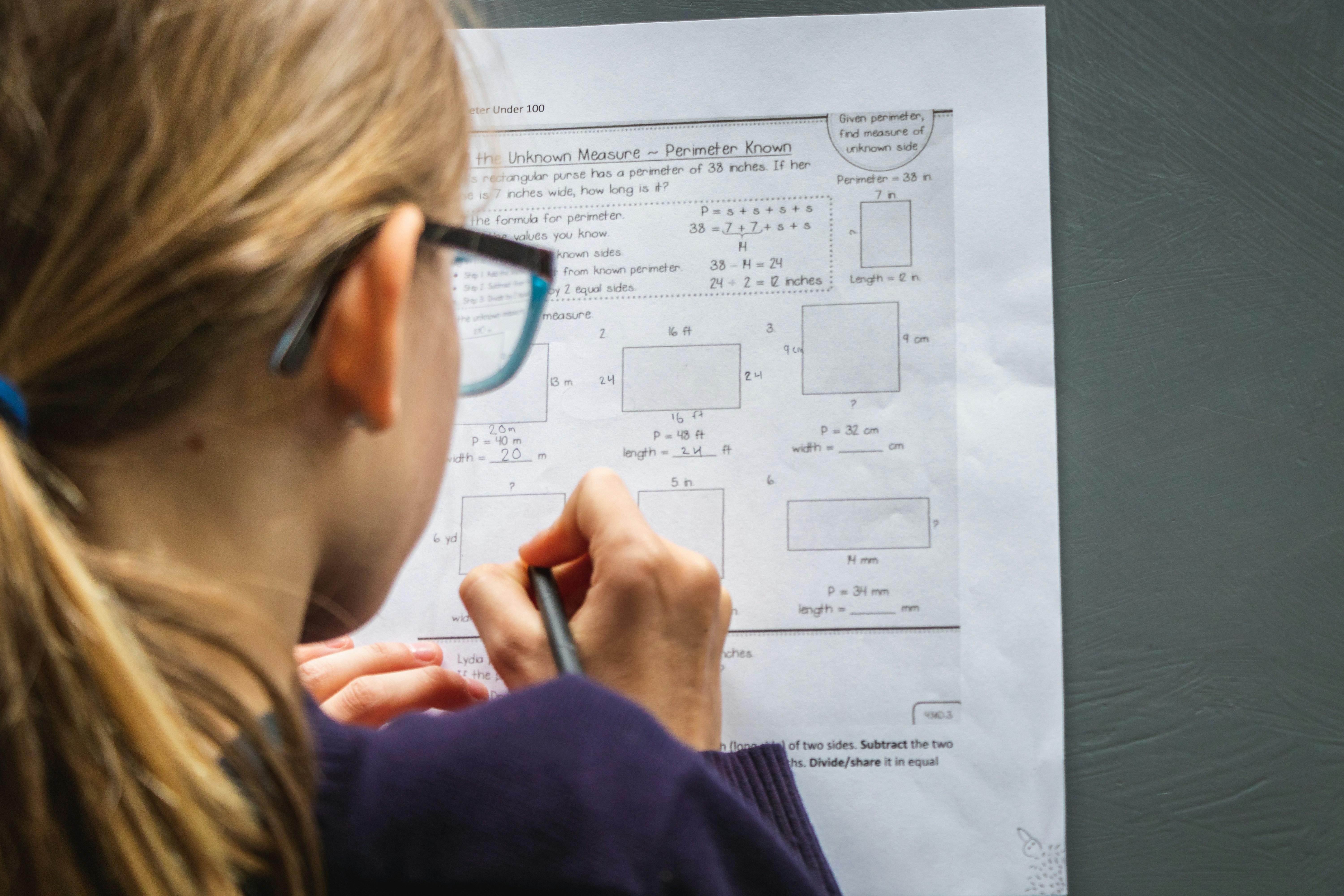 a girl studying hard with a pen