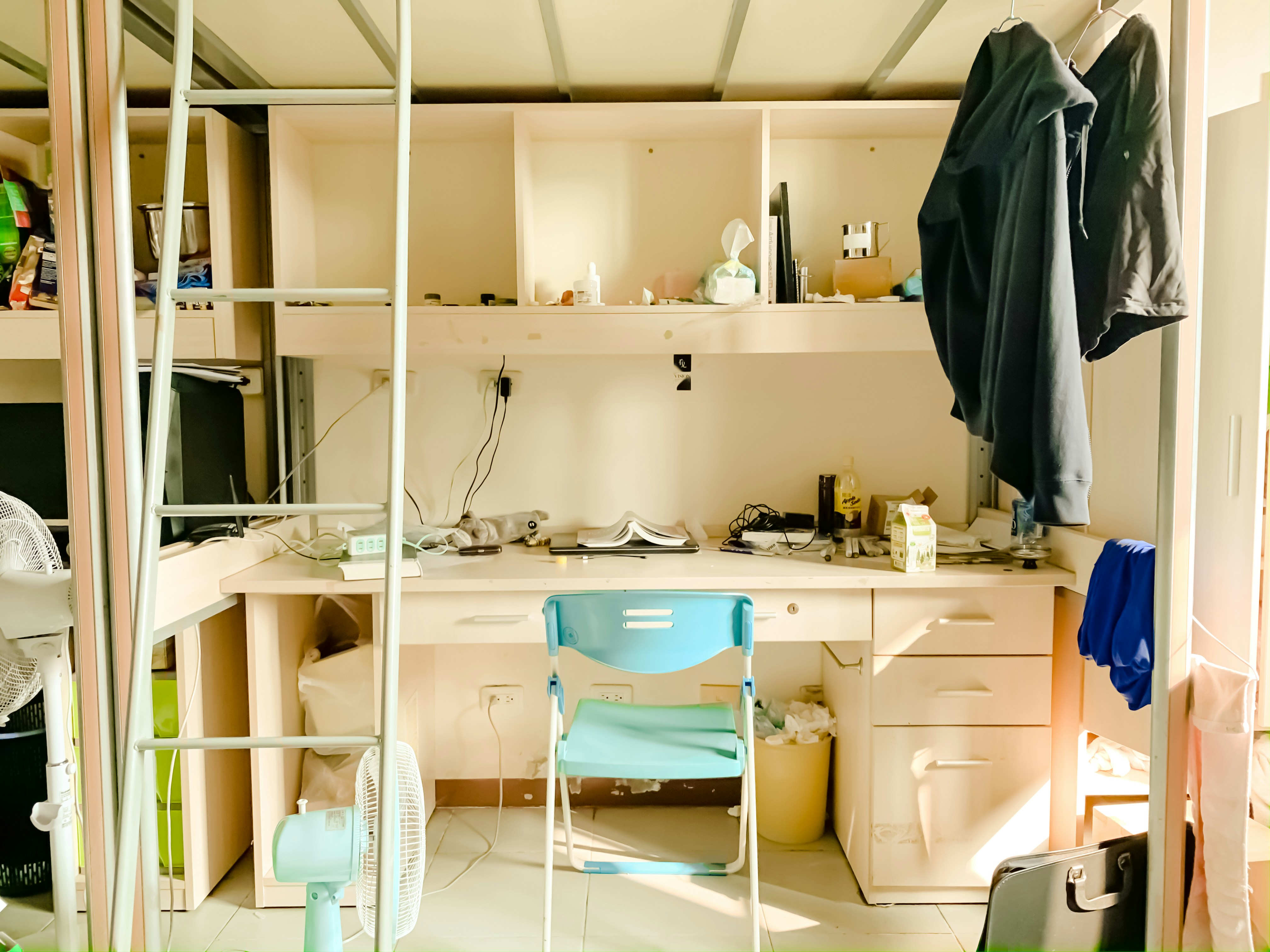 a desk, a chair and a bed