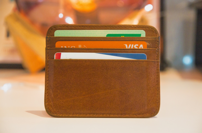 a brown wallet with many bank cards