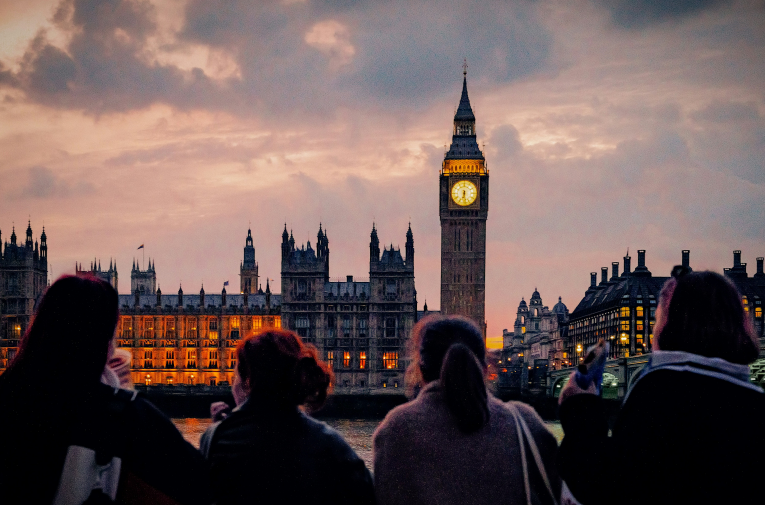 a group of people standing in front of big ben in London