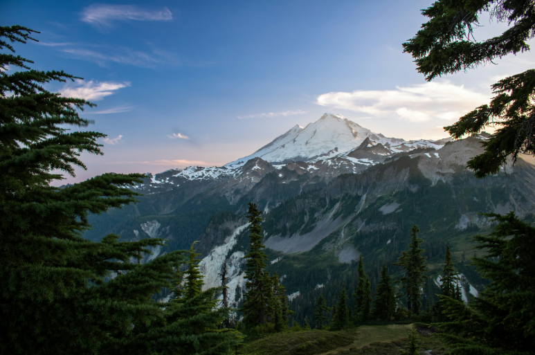 a view of snow covered mountain on a top of hill