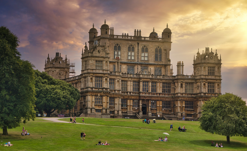 people lying on a grassland in front of the university building in the UK