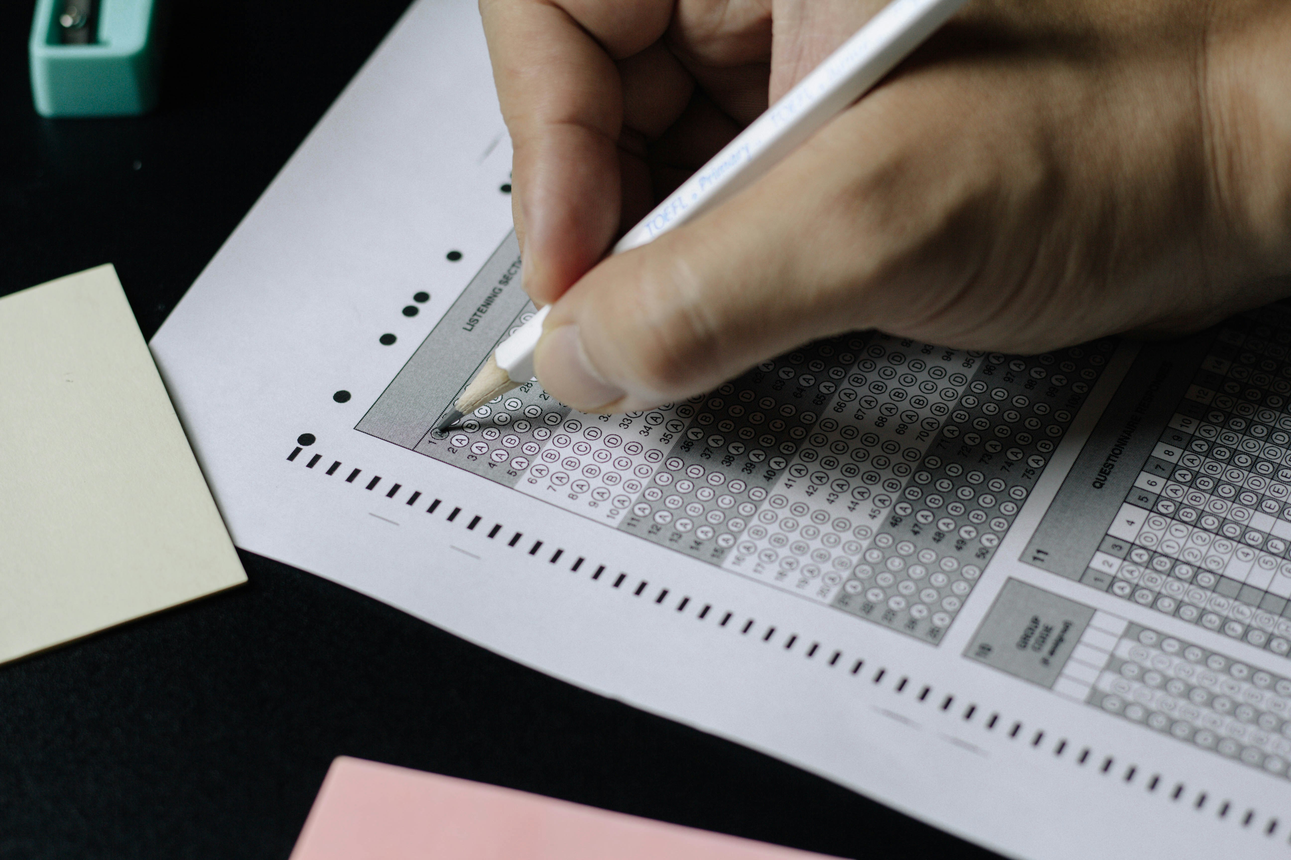 person writing an exam paper