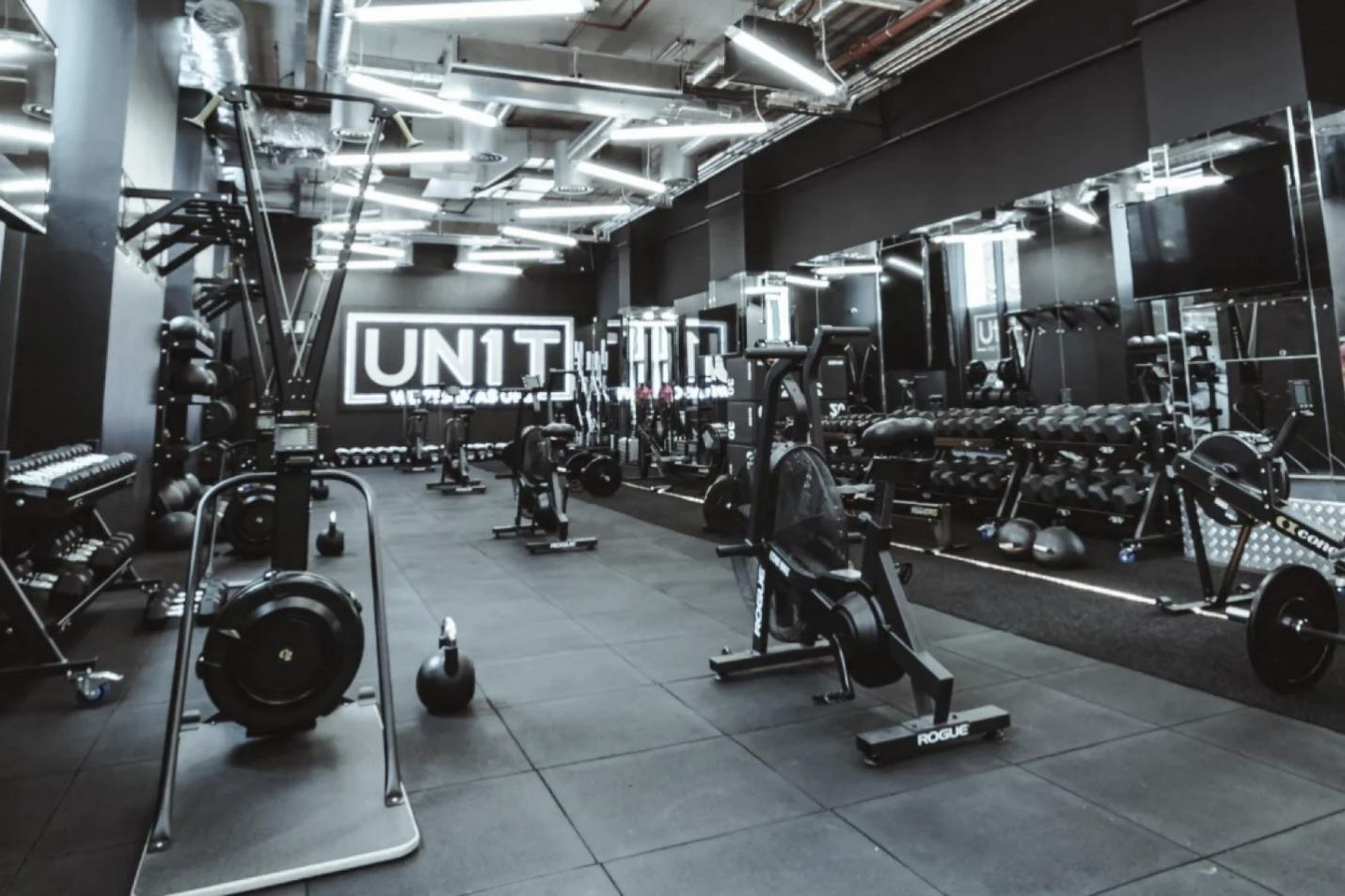 a gym with many equipments and dark lights
