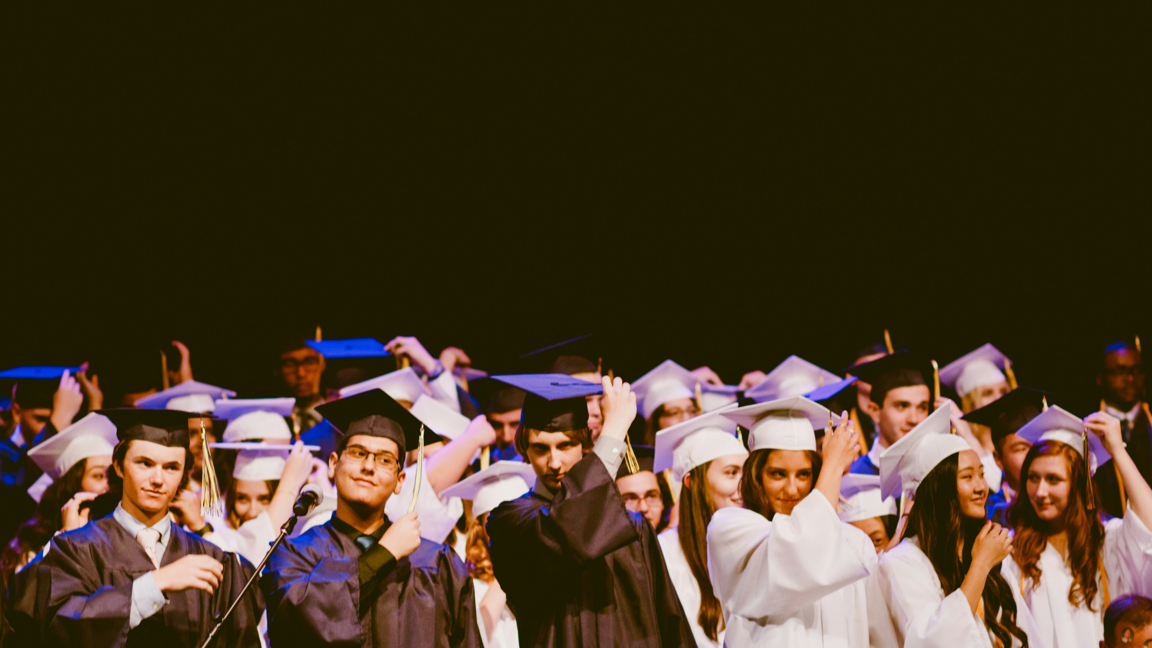 men and women wearing graduation dress inside a building
