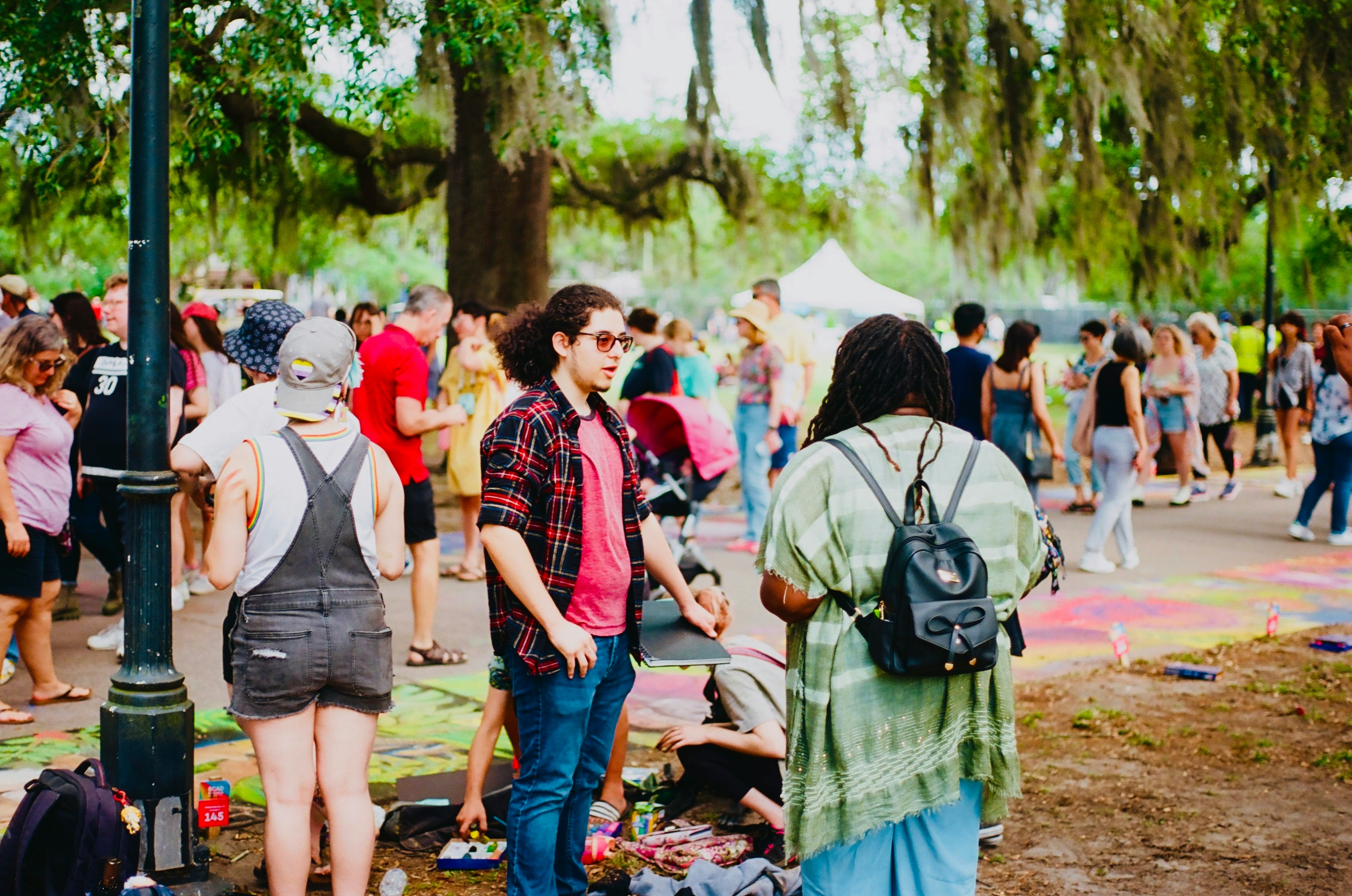 campus students walking and communicating in a park