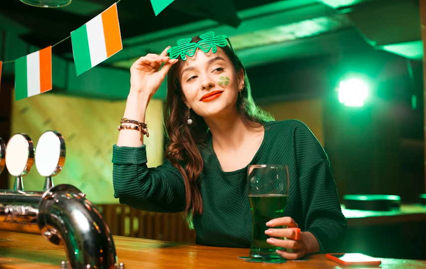a girl wearing a shamrock glass, drinking beer, celebrating Irish festival