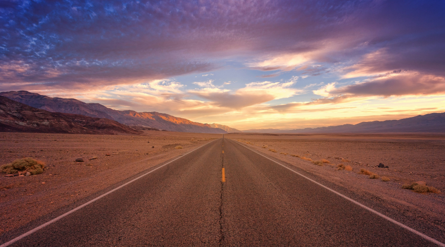 brown concrete road in death valley during daytime