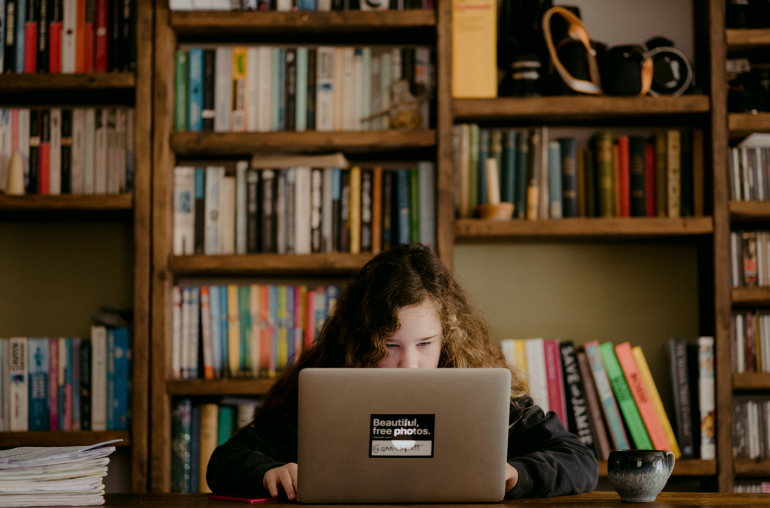 a woman in long sleeve using a laptop