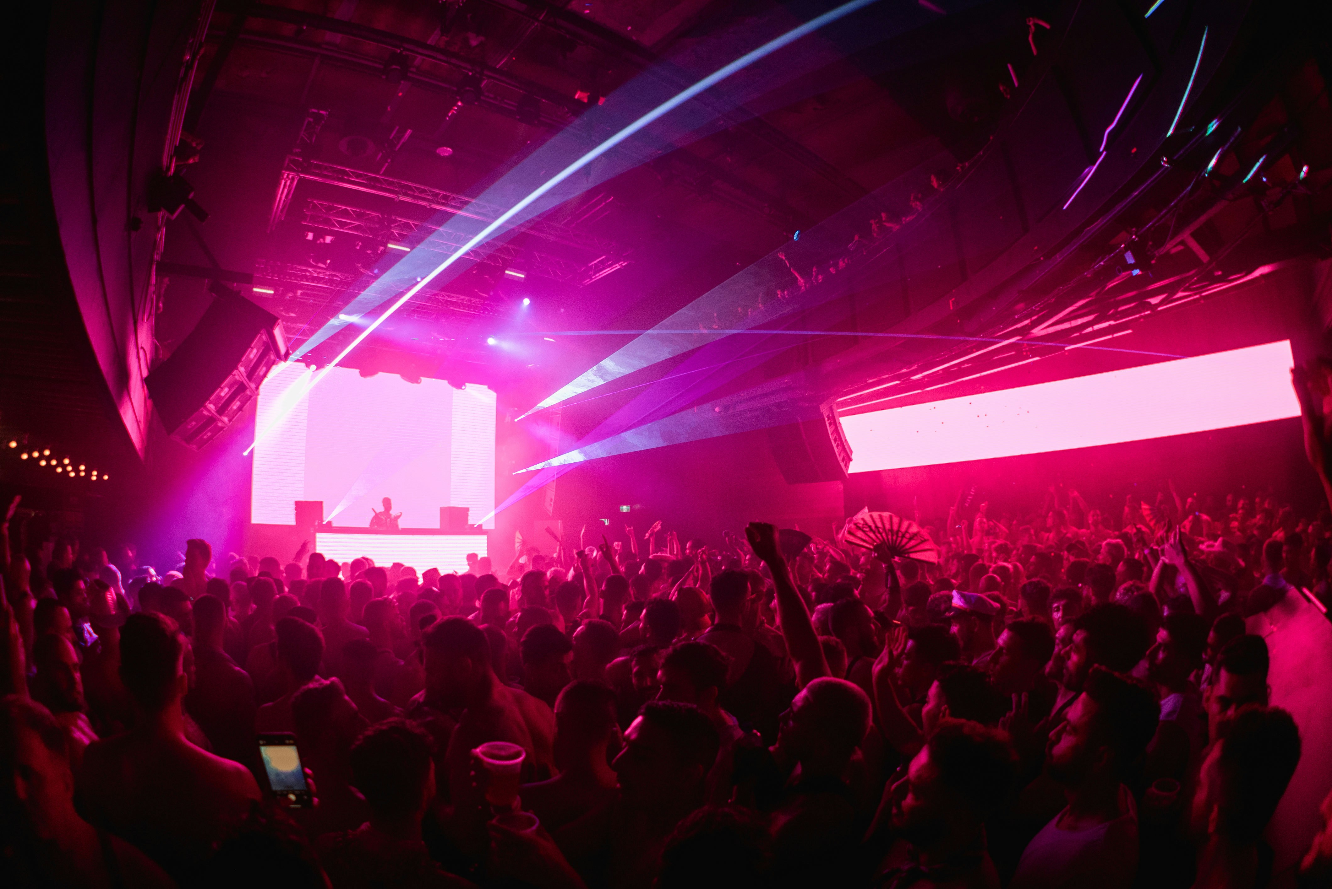 a large crowd of people dancing in a club