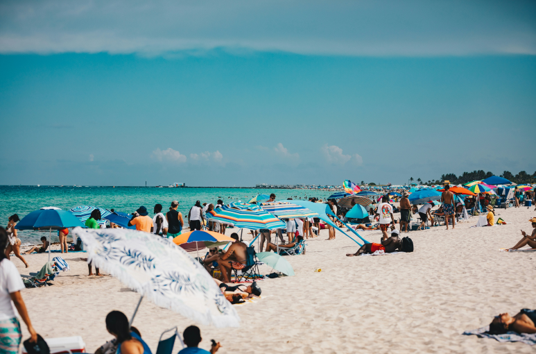 people lying on the beach in Miami relaxed