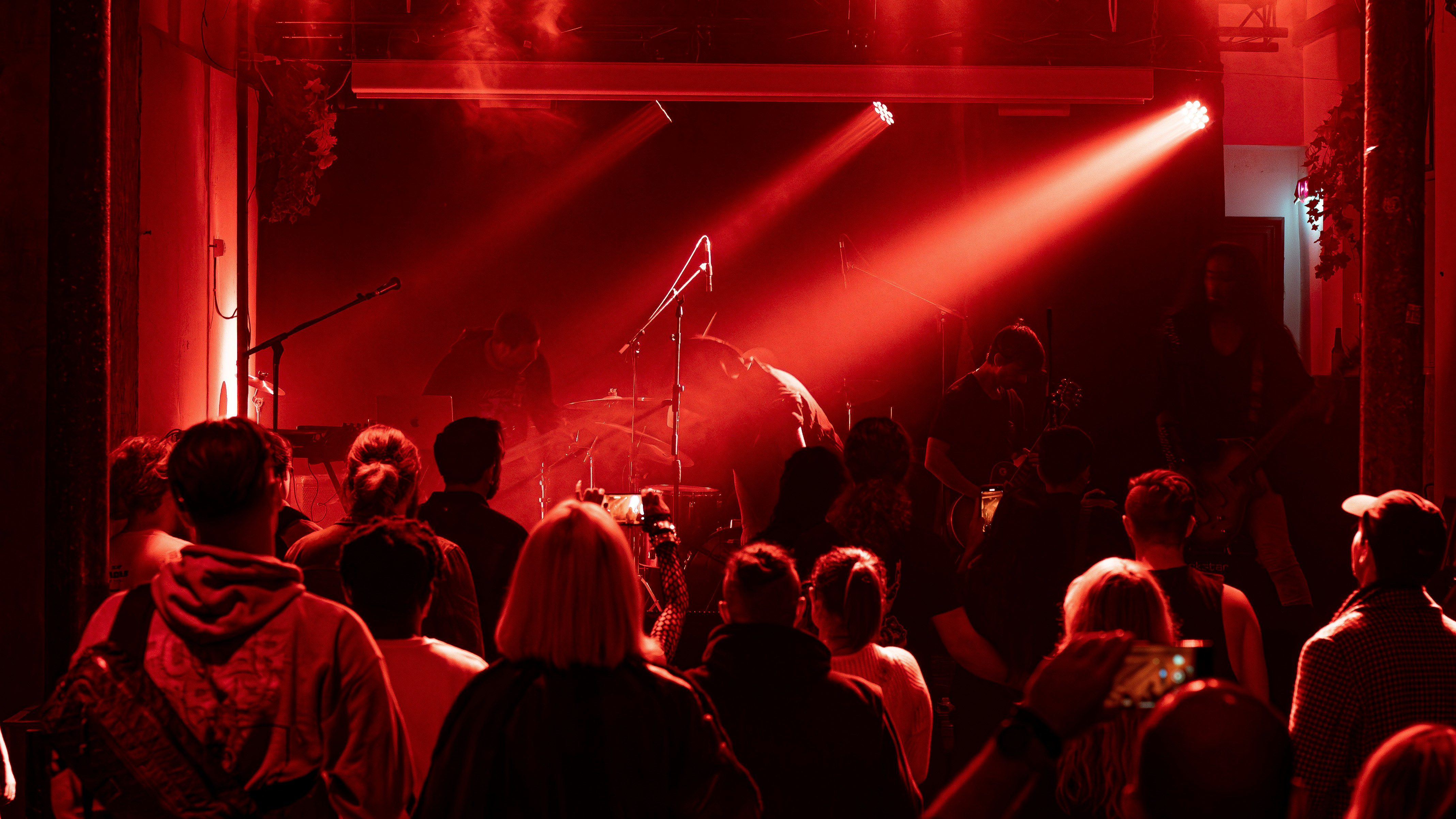 a crowd of people standing around a stage in a nightclub