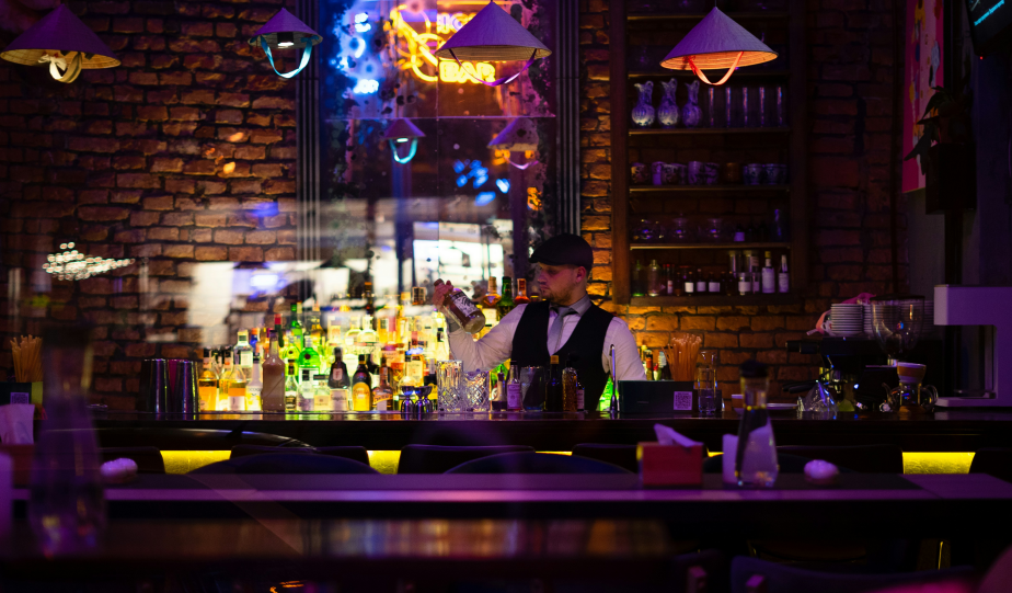 a man sitting behind the bar making drinks