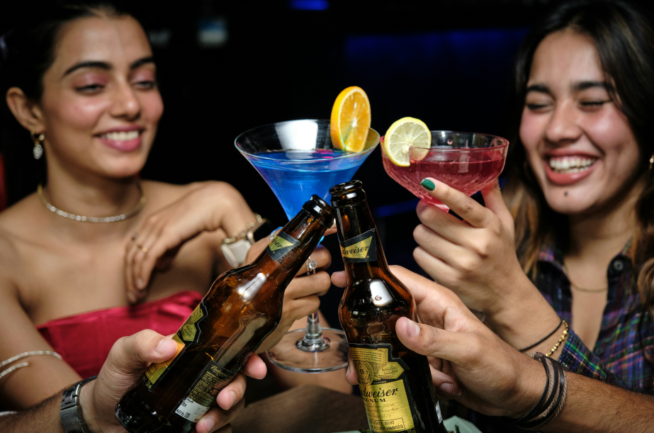 a group of people at the same table drink wines
