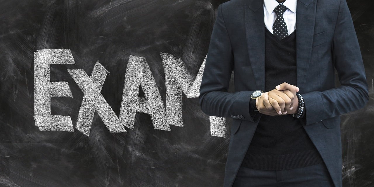 a-man-standing-in-front-of-blackboard-written-exam