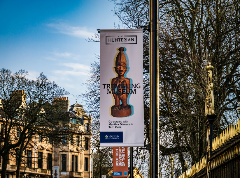 a sign on a pole inside university of Glasgow