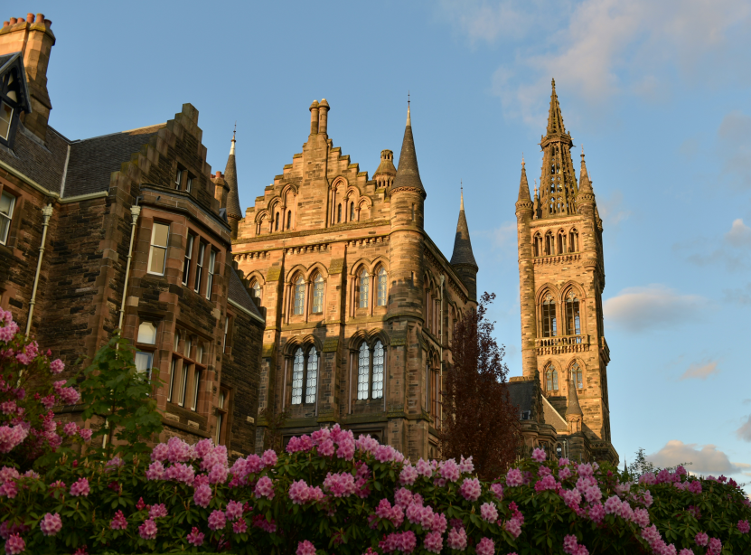 brown concrete building in University of Glasgow under blue sky